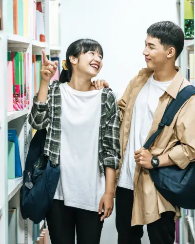 Students walking on aisle of book store