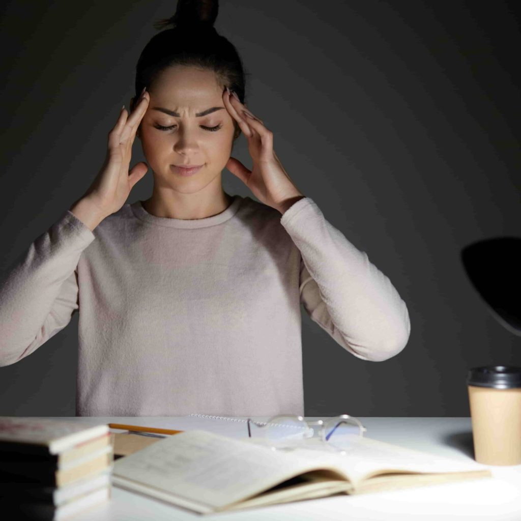 Young woman wears casual shirt reading and feeling tired